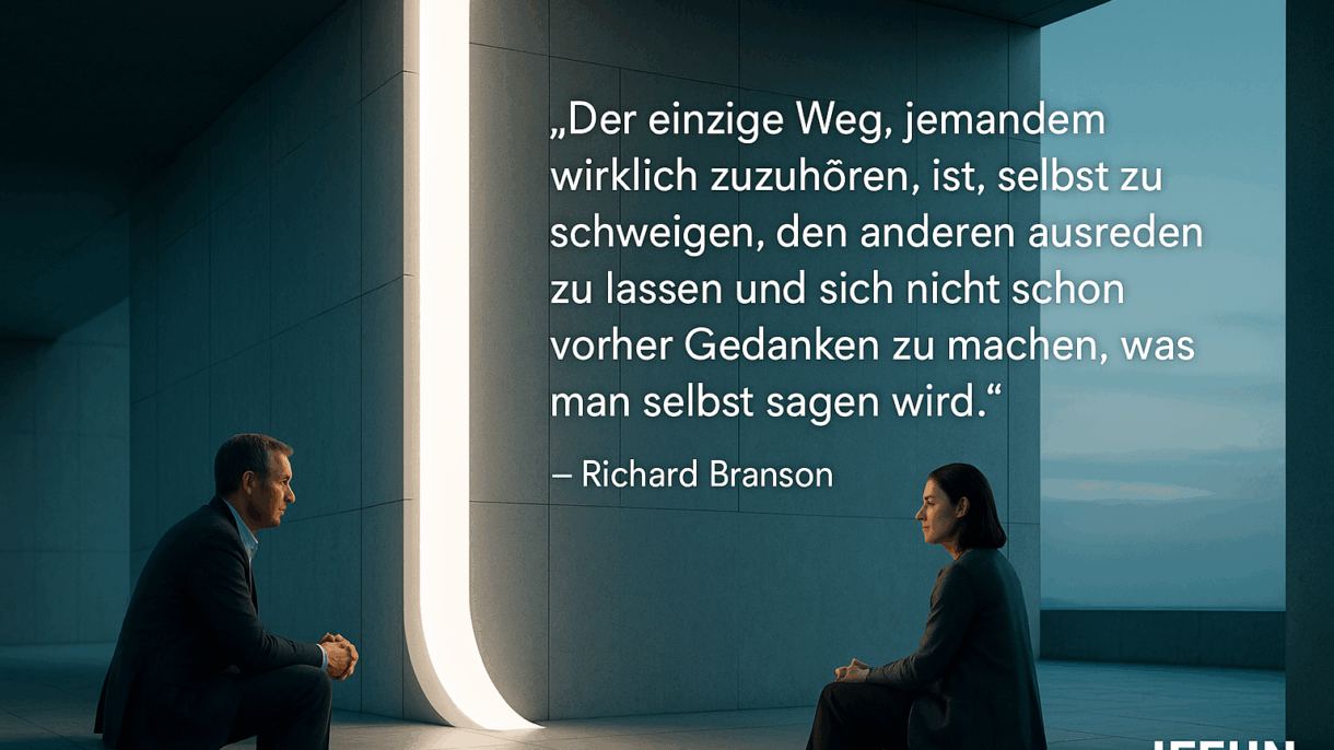 Zwei Personen im Gespräch vor beleuchteter Wand.